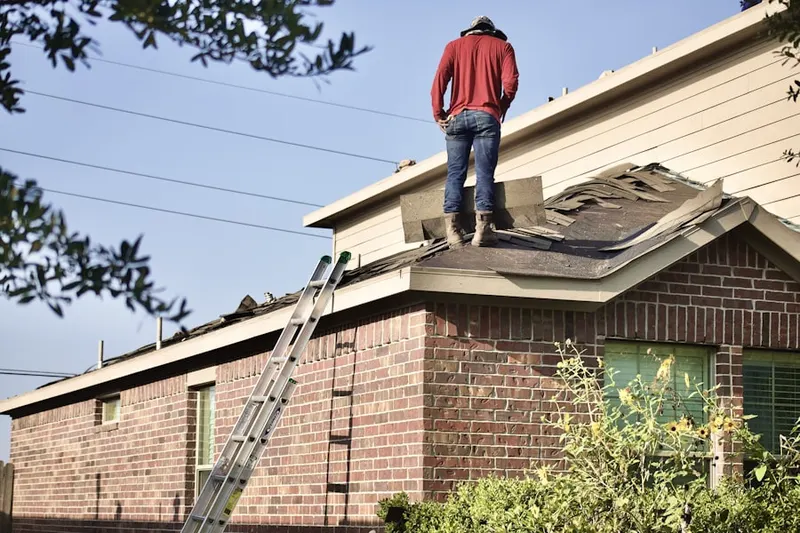 Professional roofer working on a residential roof in Little Georgetown